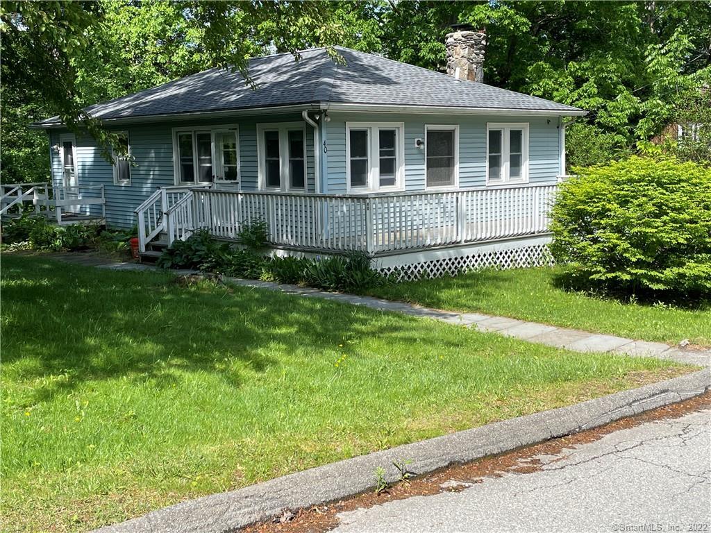 a front view of a house with a yard and porch