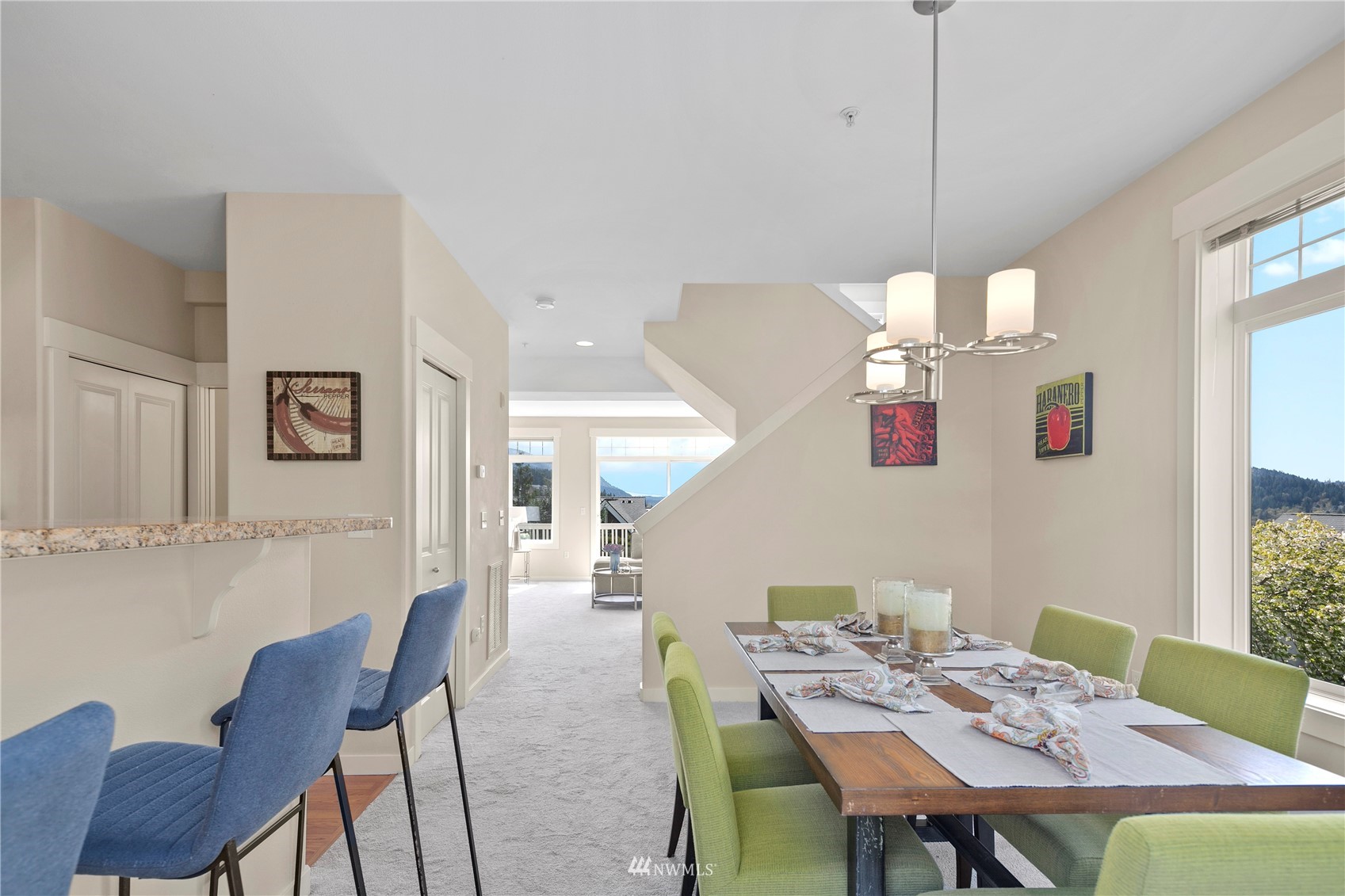 23120 Southeast Black Nugget Road, Unit H1 Issaquah, WA 98029 - Photo 13 of 27 a view of a dining room with furniture a chandelier and wooden floor