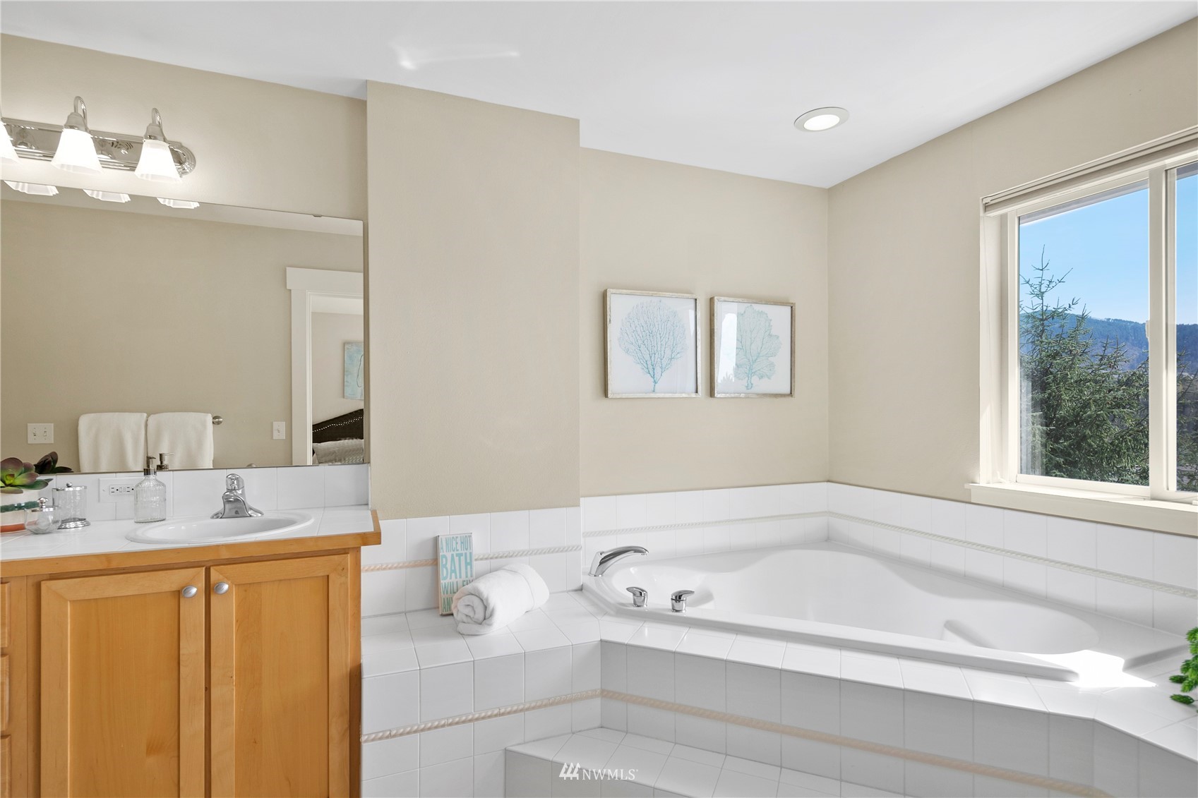 23120 Southeast Black Nugget Road, Unit H1 Issaquah, WA 98029 - Photo 16 of 27 a bathroom with a granite countertop sink tub and a mirror