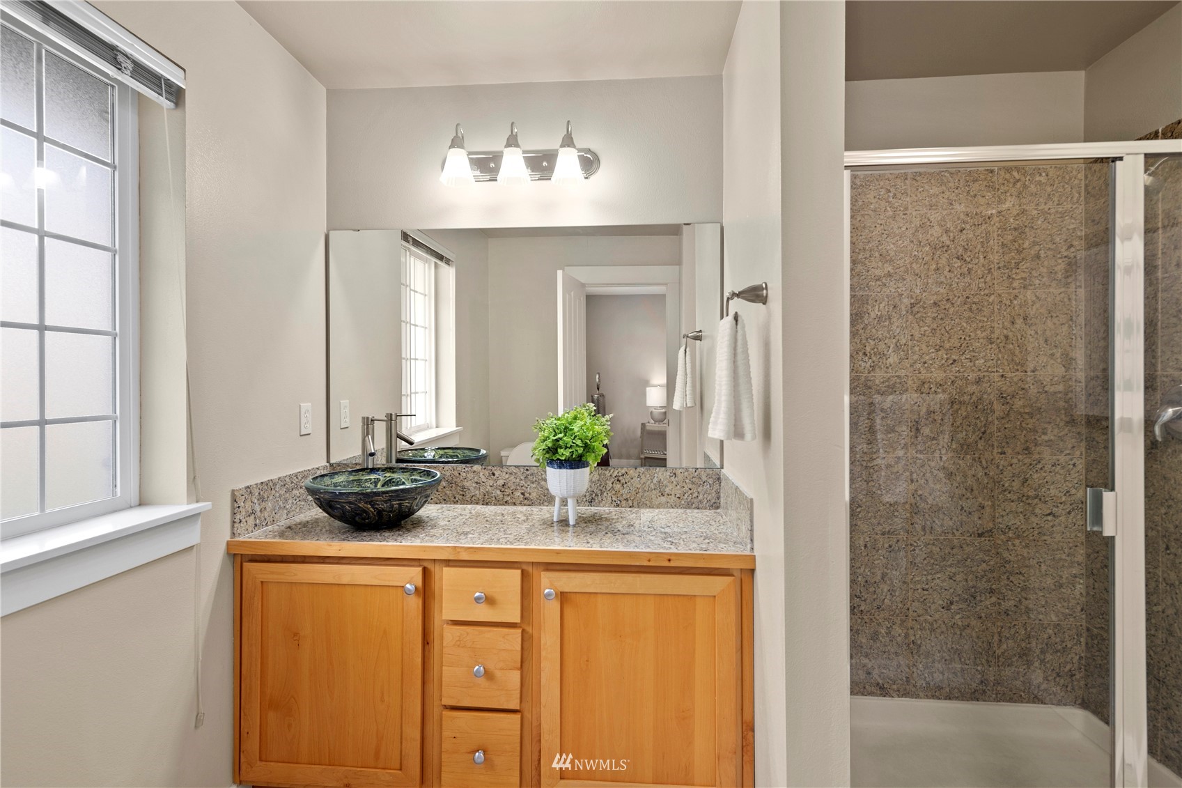 23120 Southeast Black Nugget Road, Unit H1 Issaquah, WA 98029 - Photo 22 of 27 a bathroom with a sink and a mirror