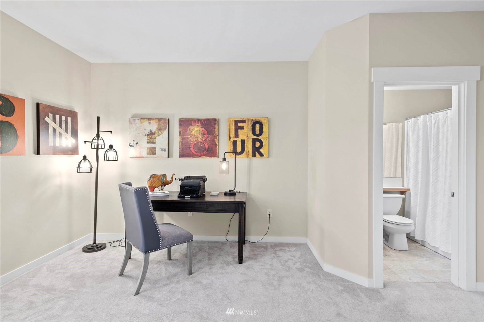 23120 Southeast Black Nugget Road, Unit H1 Issaquah, WA 98029 - Photo 24 of 27 a view of a workspace with furniture and a painting on the wall