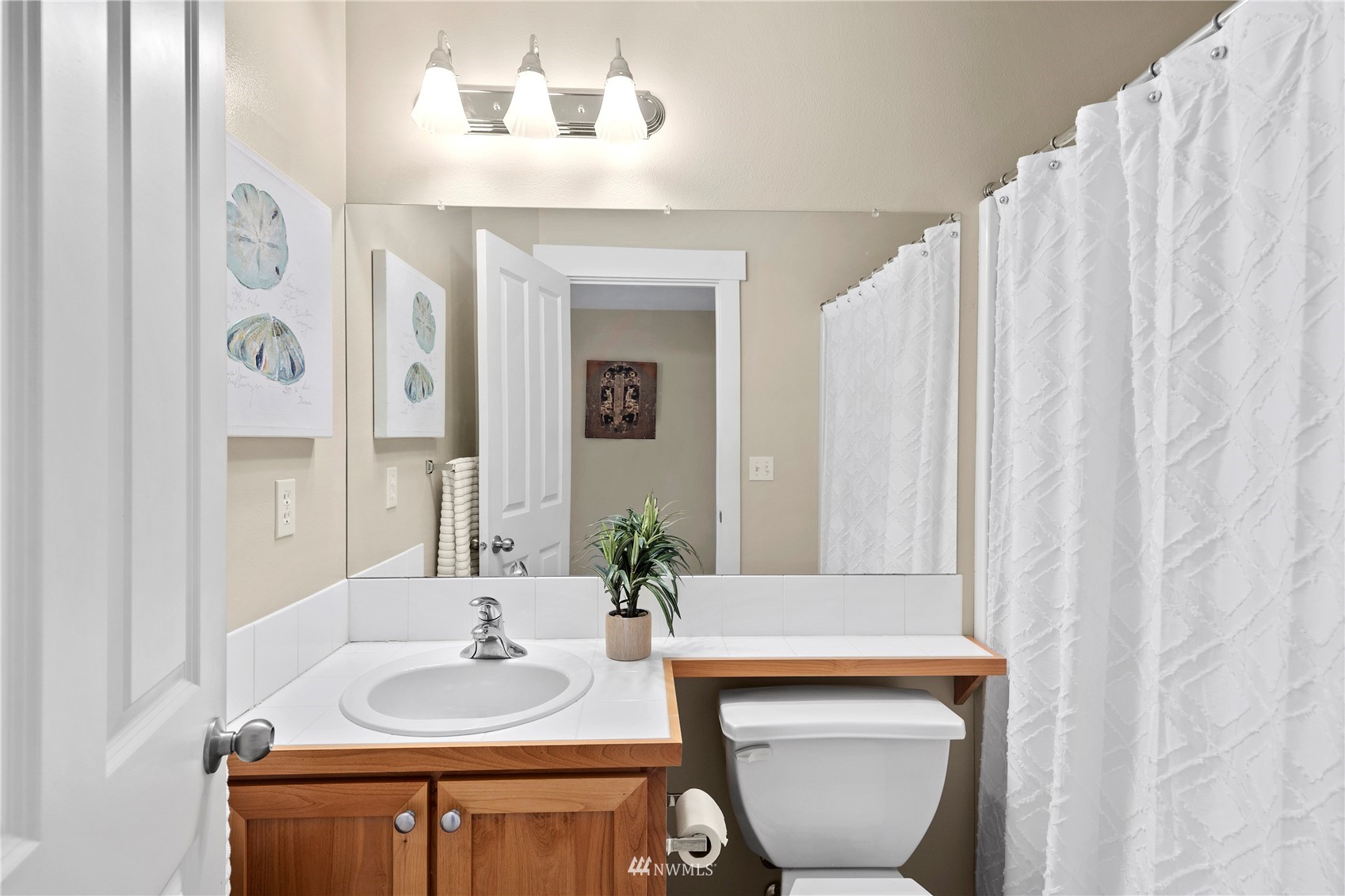 23120 Southeast Black Nugget Road, Unit H1 Issaquah, WA 98029 - Photo 26 of 27 a bathroom with a sink and a mirror