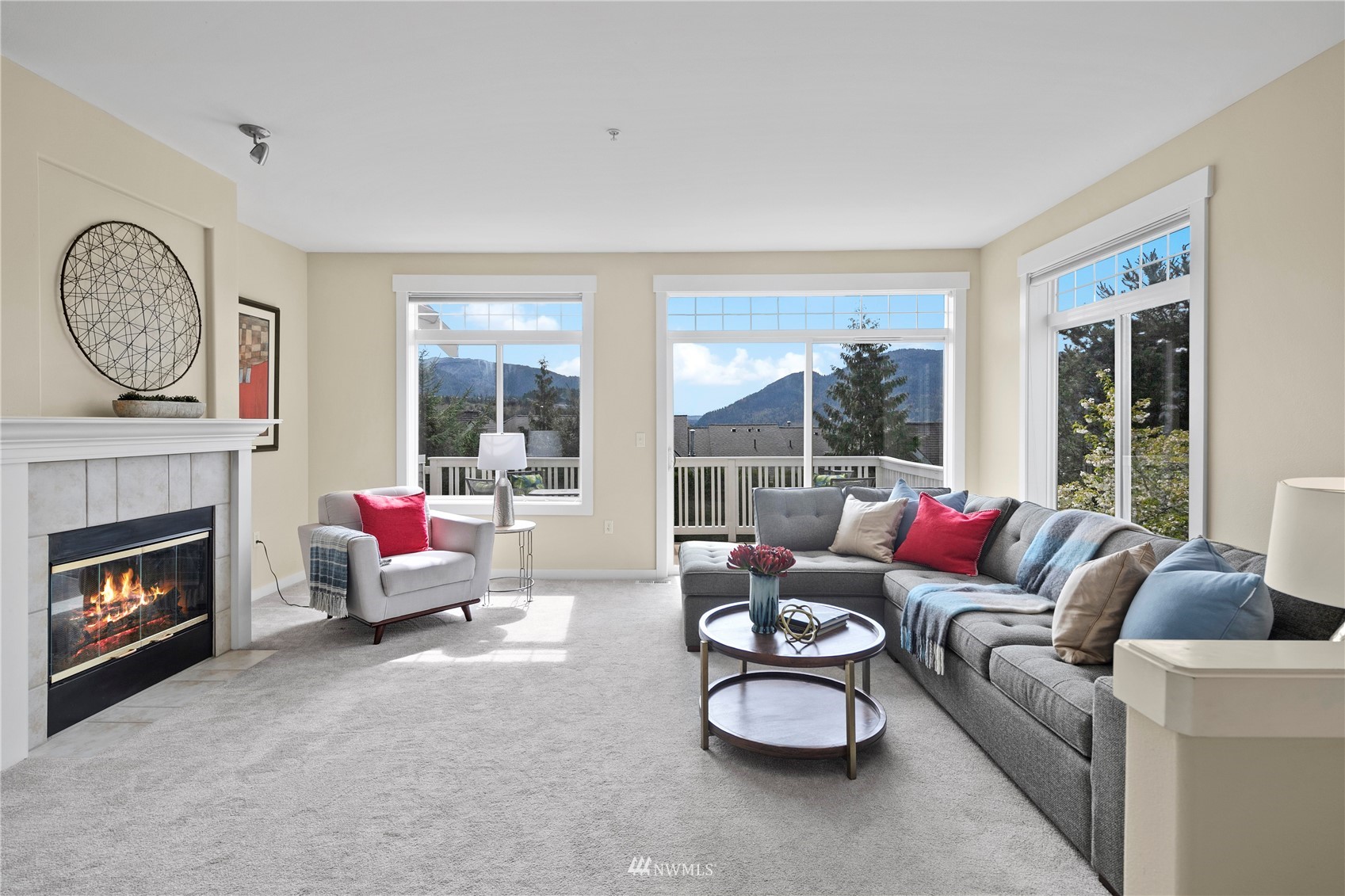 23120 Southeast Black Nugget Road, Unit H1 Issaquah, WA 98029 - Photo 3 of 27 a living room with furniture a fireplace and a large window