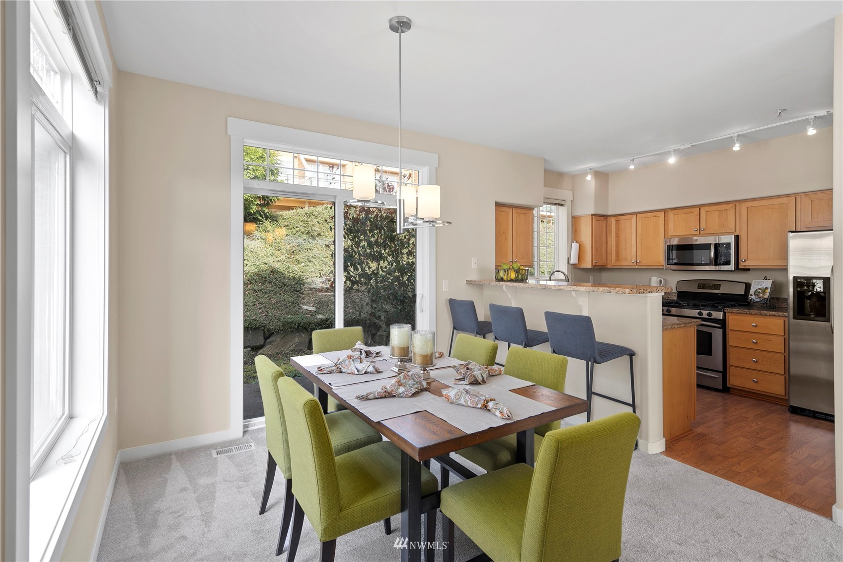 23120 Southeast Black Nugget Road, Unit H1 Issaquah, WA 98029 - Photo 8 of 27 a view of a dining room with furniture window and wooden floor