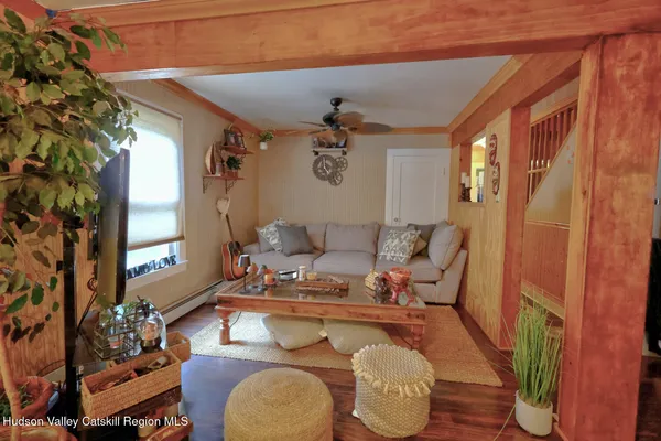 a kitchen with stainless steel appliances granite countertop a refrigerator a stove a sink dishwasher and a dining table with wooden floor