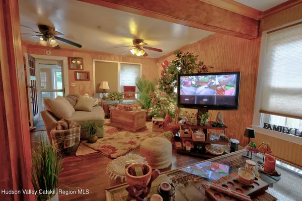 a bedroom with furniture and a flat screen tv