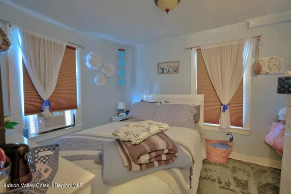 a bedroom with a bed and window