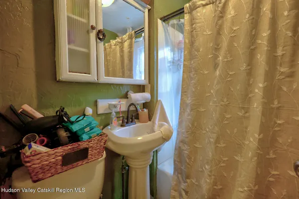 a bathroom with a sink toilet and mirror