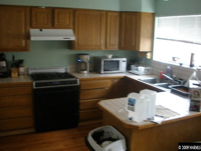 3640 Shale Court Reno, NV 89503 - Photo 3 of 6 a kitchen with a sink a stove and cabinets