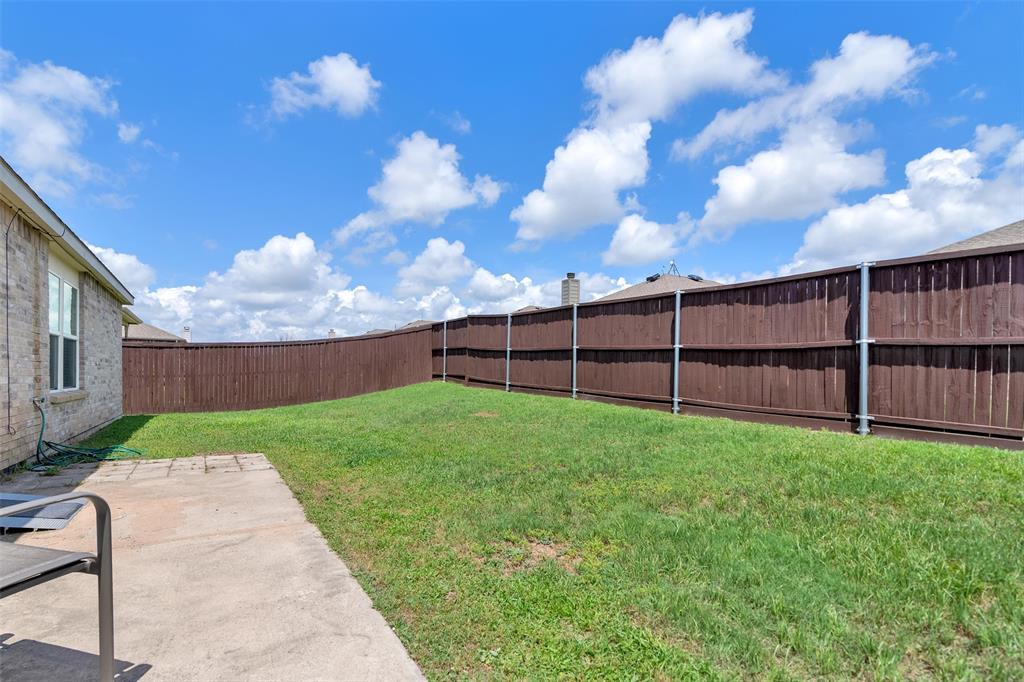 3011 Hickory Ridge Melissa, TX 75454 - Photo 24 of 30 Expansive backyard featuring a manicured lawn, a concrete patio area, and a privacy fence