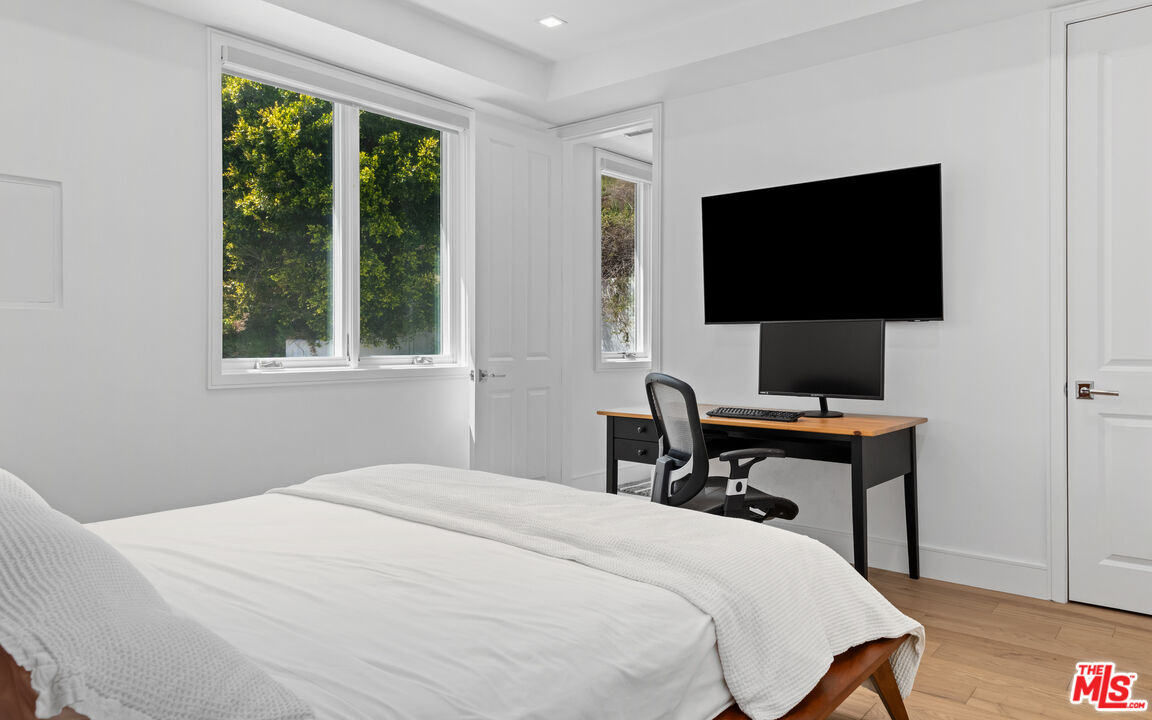 25157 Malibu Road Malibu, CA 90265 - Photo 21 of 33 a bedroom with a bed and a flat screen tv