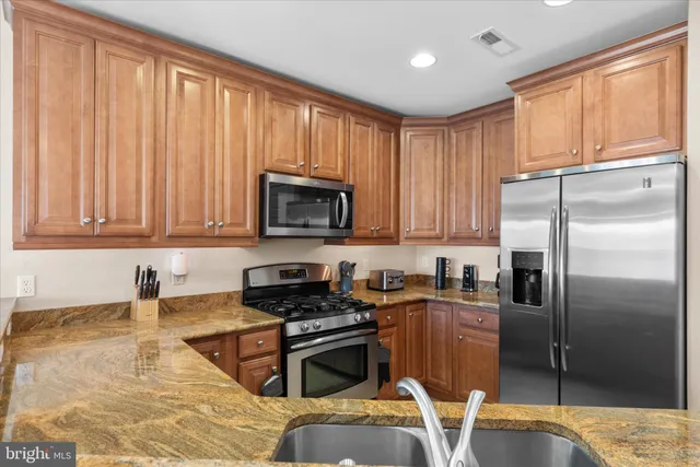 a kitchen with microwave a stove and furniture