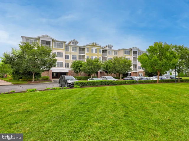 a front view of a house with a garden and plants