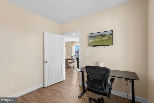 a bedroom with a bed and a lamp on dresser