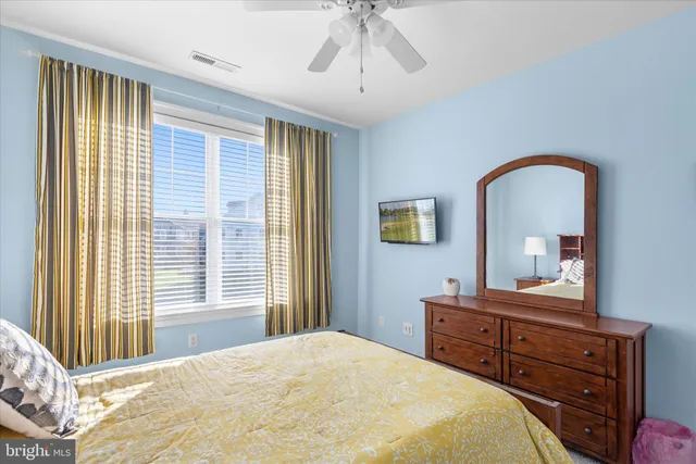 a spacious bedroom with a bed and window