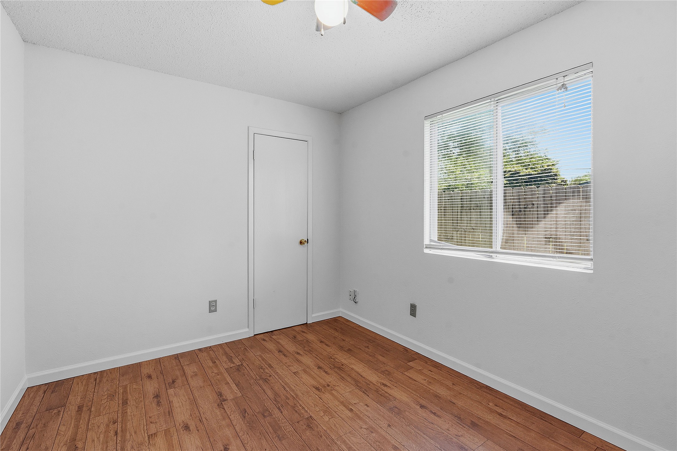 6205 Shadow Bend Austin, TX 78745 - Photo 24 of 31 A well-lit bedroom features durable hardwood flooring and a functional window.