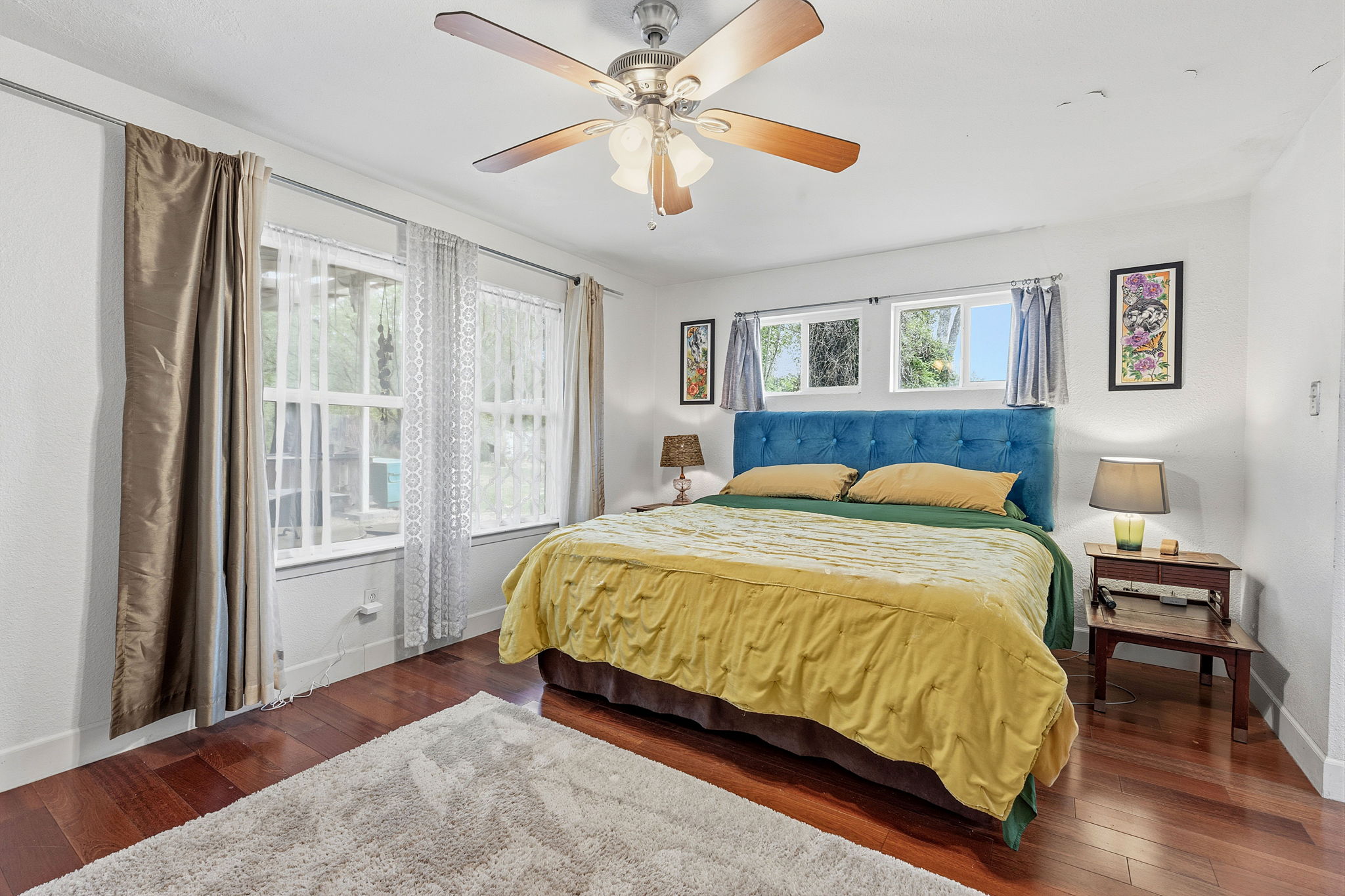 700 Corral Lane Austin, TX 78745 - Photo 13 of 26 a bedroom with a bed and a chandelier