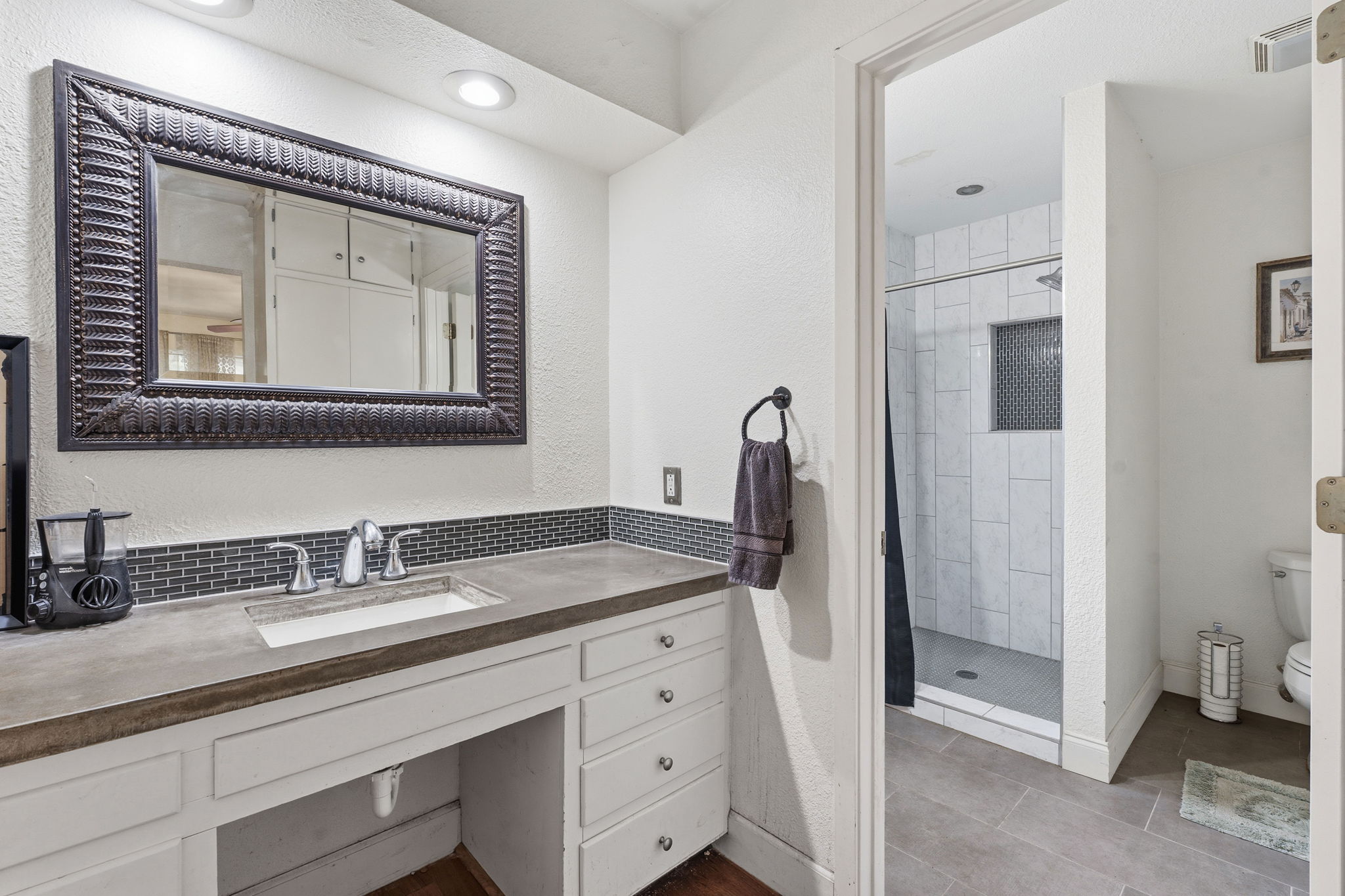 700 Corral Lane Austin, TX 78745 - Photo 14 of 26 a bathroom with a double vanity sink and mirror