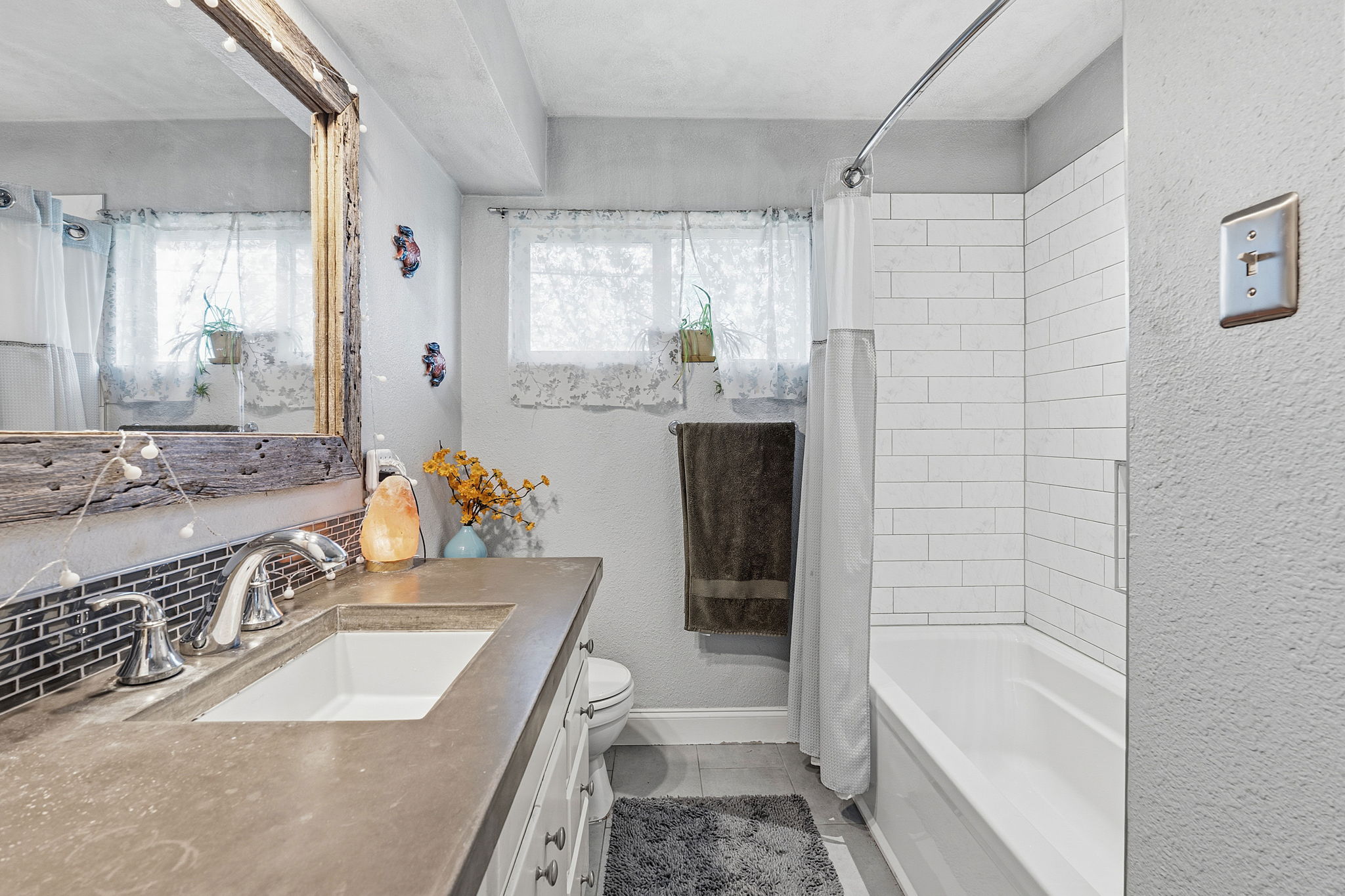 700 Corral Lane Austin, TX 78745 - Photo 16 of 26 a bathroom with a granite countertop tub sink and mirror