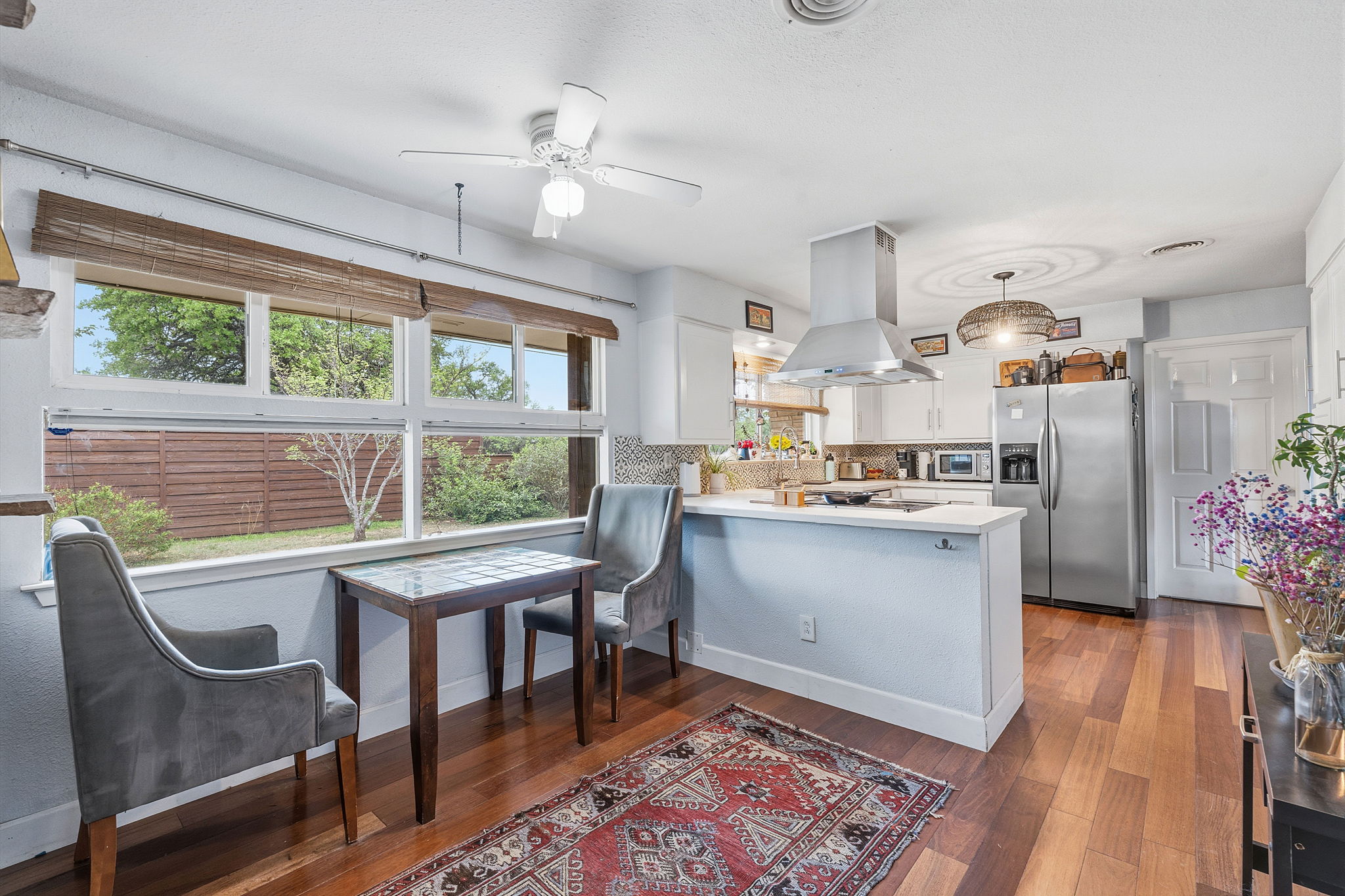 700 Corral Lane Austin, TX 78745 - Photo 7 of 26 a kitchen with a table chairs refrigerator and cabinets