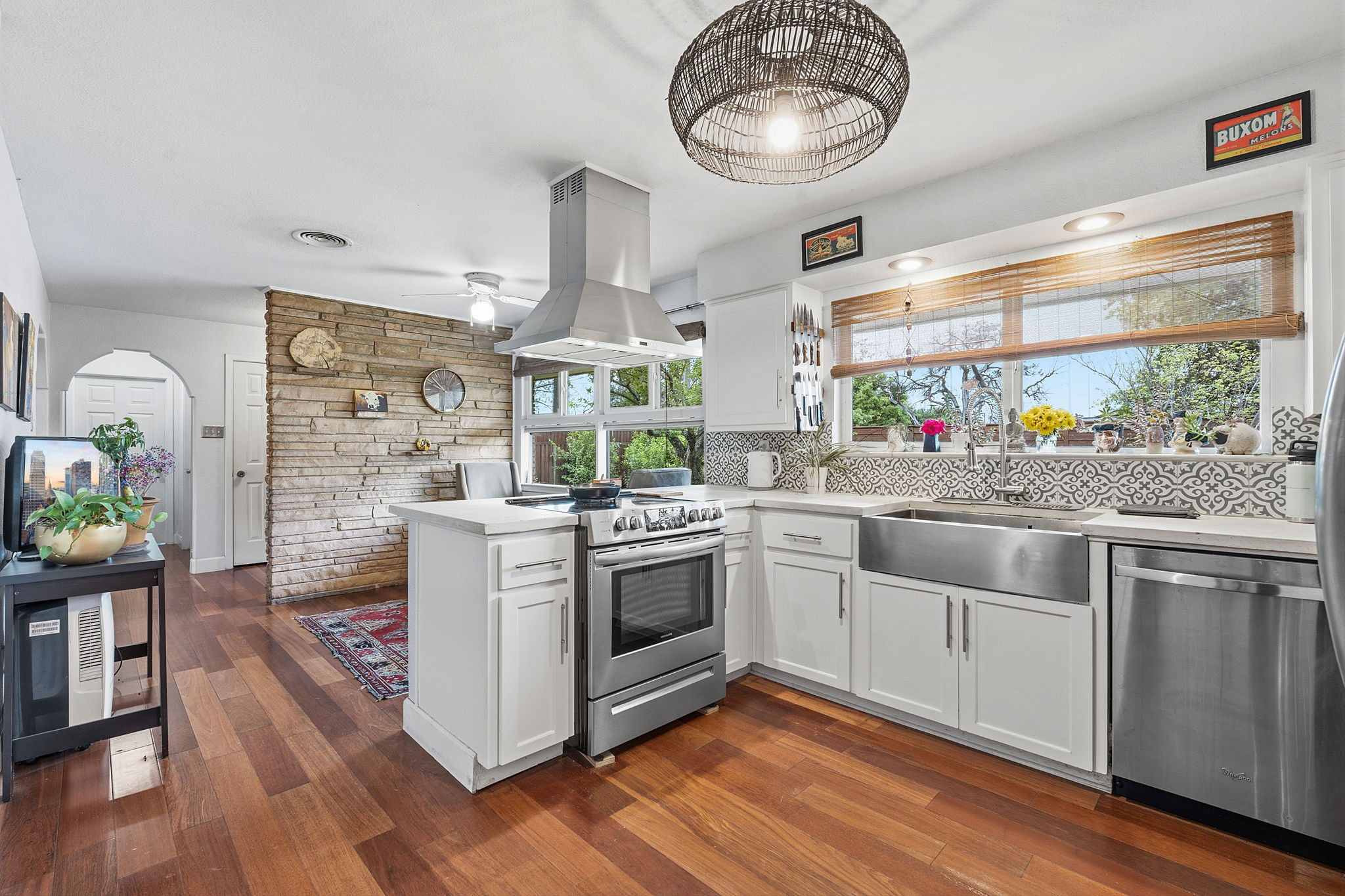 700 Corral Lane Austin, TX 78745 - Photo 8 of 26 a kitchen with stainless steel appliances granite countertop a stove and a wooden floors