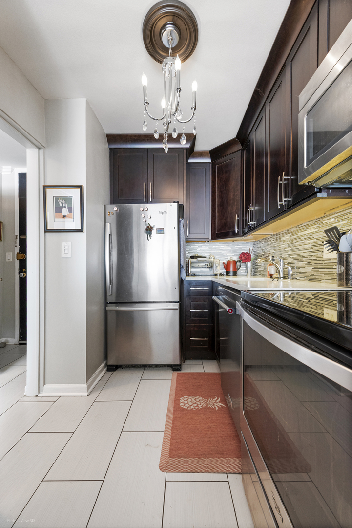 5455 North Sheridan Road, Unit 3105 Chicago, IL 60640 - Photo 13 of 18 a kitchen with stainless steel appliances granite countertop a refrigerator a stove and a sink