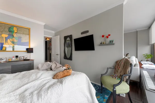 a bedroom with a bed and a flat screen tv