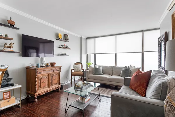 a living room with furniture a flat screen tv and a window