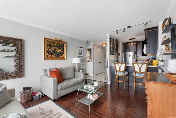 a living room with furniture and a kitchen view