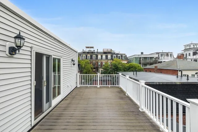 a view of a balcony with wooden floor