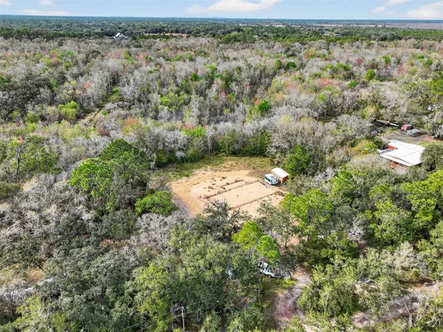 an aerial view of a houses with a yard