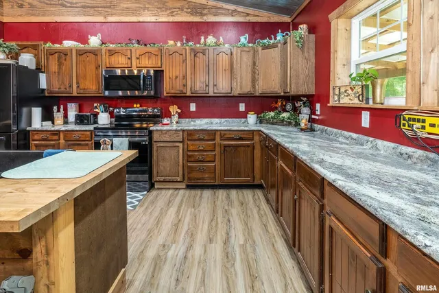 a kitchen with granite countertop a sink and wooden cabinets
