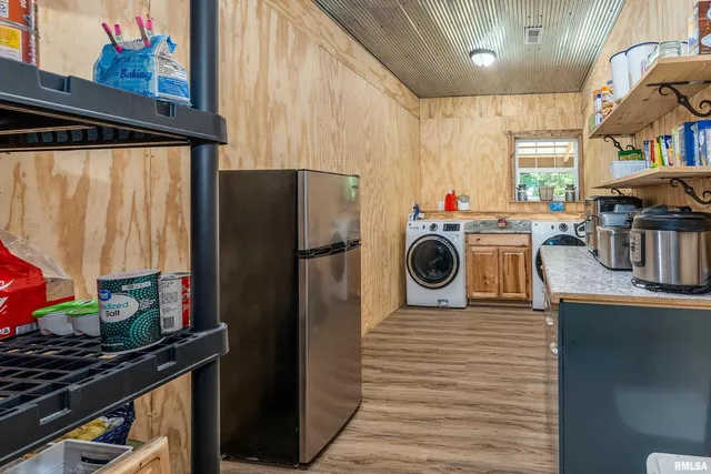 a utility room with sink dryer and washer