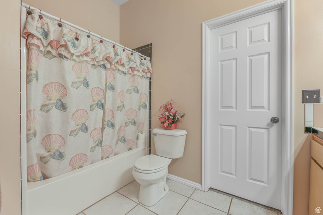 569 Elk Meadow Loop Tooele, UT 84074 - Photo 46 of 56 Bathroom with vanity, light tile patterned floors, and shower / tub combo with curtain