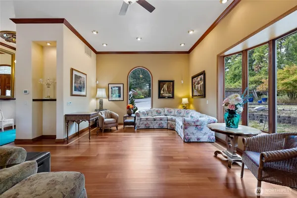 a living room with fireplace furniture and a large window
