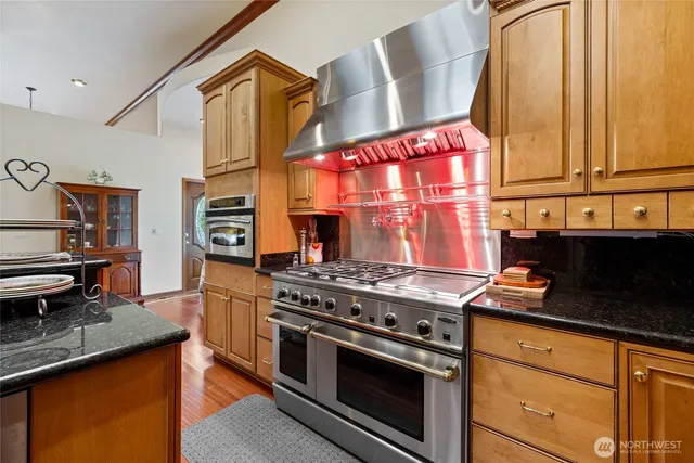 a kitchen with stainless steel appliances granite countertop a stove and a sink