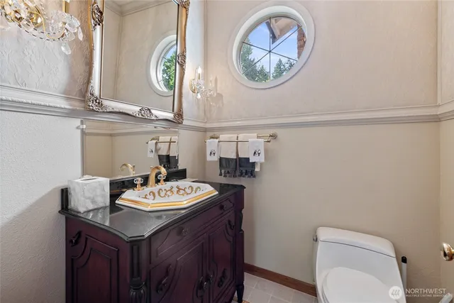 a bathroom with a sink a mirror and a toilet