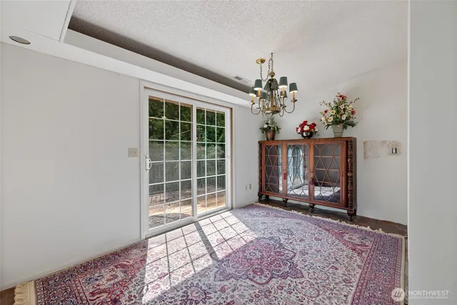a view of a livingroom with wooden floor and a bookshelf