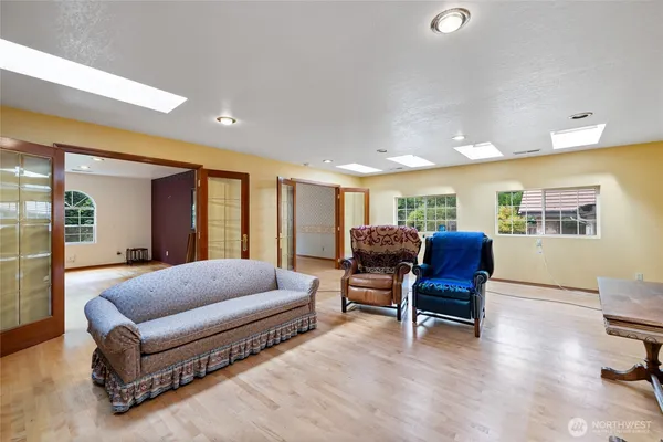 a bedroom with furniture and wooden floor