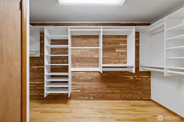 a view of a room with wooden floor and windows