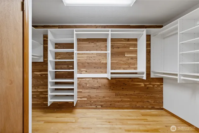 a view of a room with wooden floor and windows