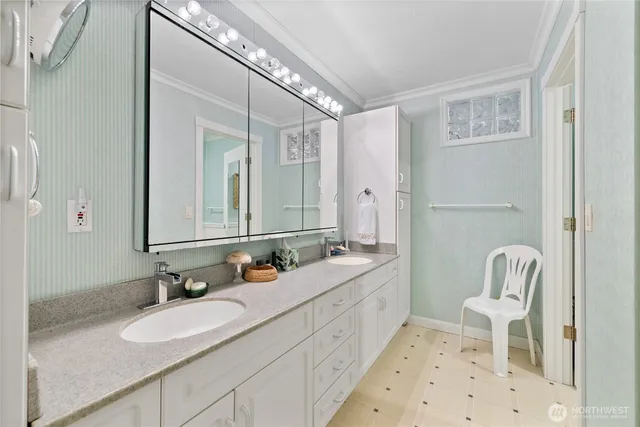 a bathroom with a double vanity sink mirror and toilet