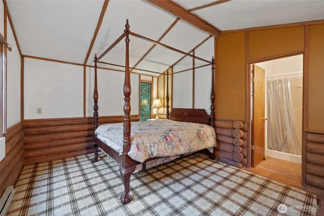 a bedroom with a bed and a mirror