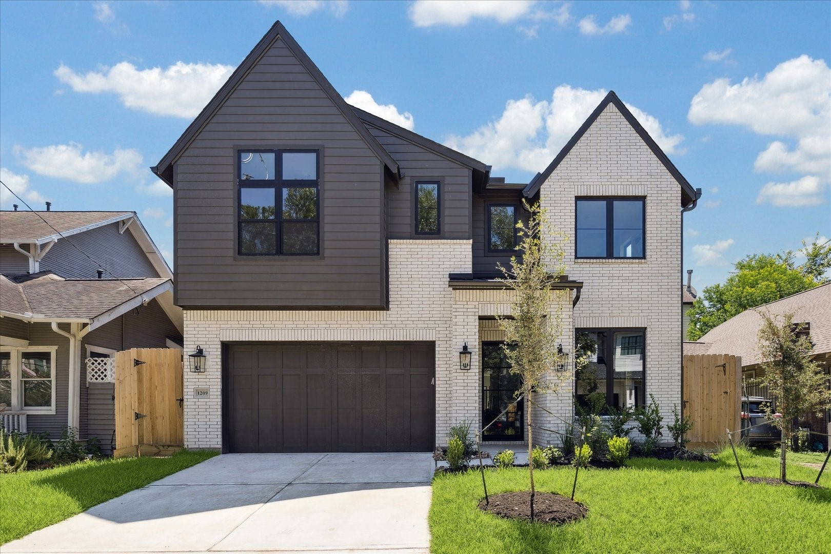 1209 Willard Street Houston, TX 77006 - Photo 5 of 35 a front view of a house with a yard and garage