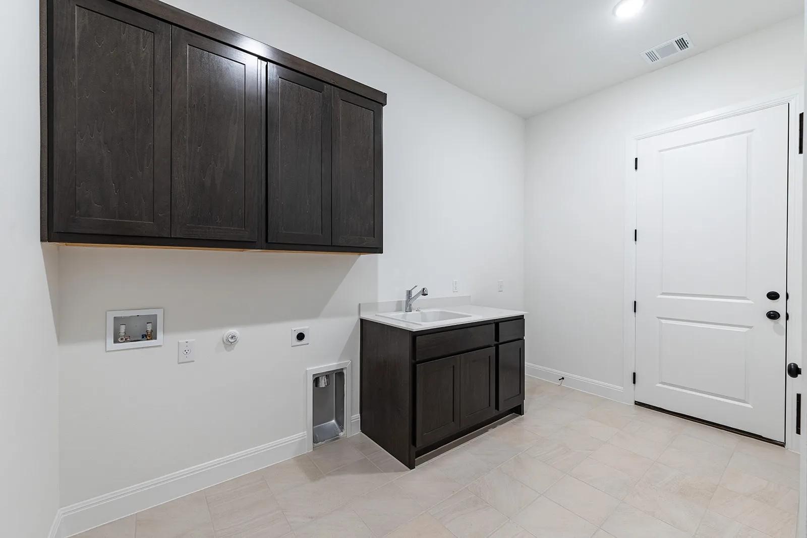 308 Buckaroo Drive Georgetown, TX 78633 - Photo 22 of 31 a utility room with cabinets