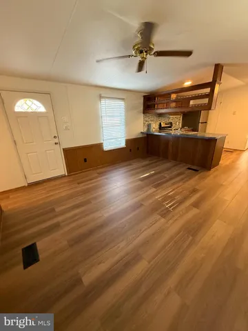 a view of a room with wooden floor
