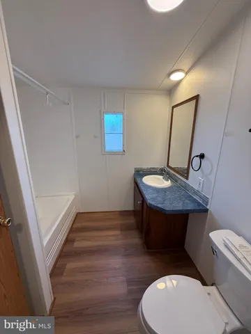 a bathroom with a toilet a sink and a mirror