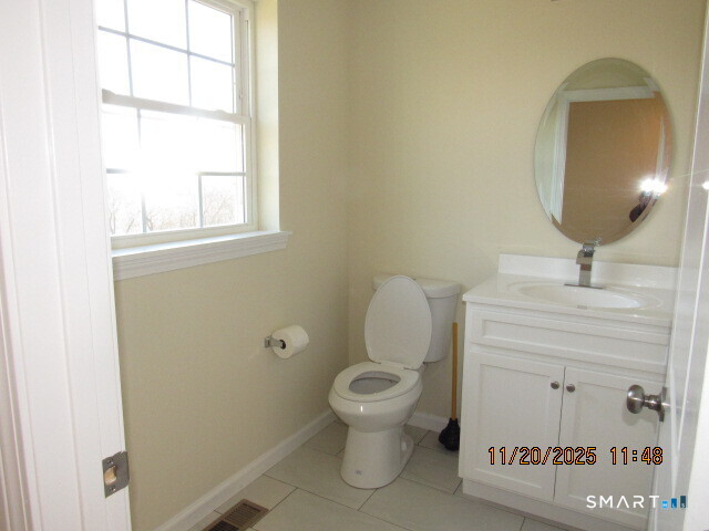 31 Warm Earth Road Naugatuck, CT 06770 - Photo 12 of 31 a bathroom with a toilet a sink and mirror