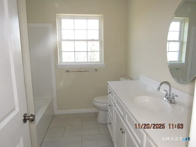 a bathroom with a sink a toilet and window