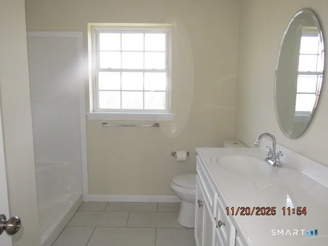 a bathroom with a sink a toilet and window
